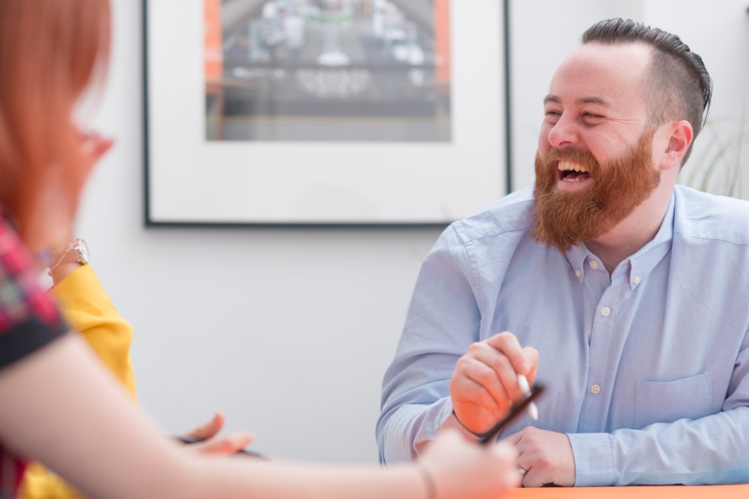 Colleagues interating with laughter in office studio